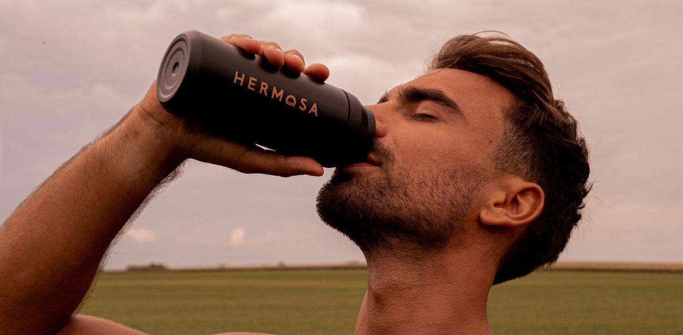 Image of a man drinking a HERMOSA shake